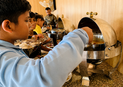 Students serving food at SRCS